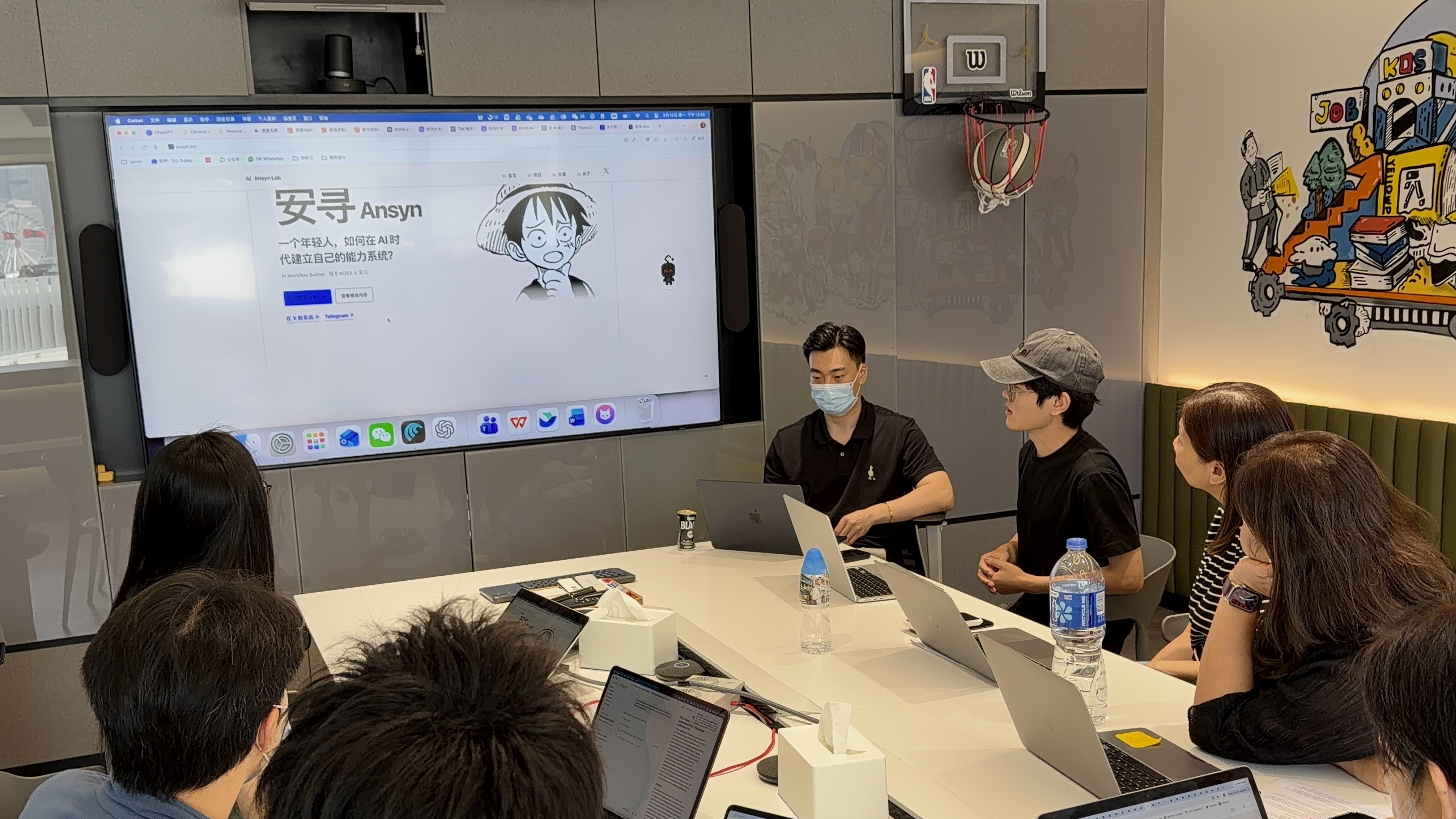 Ansyn, wearing a cap, introducing himself at KOSX with his website on the screen.