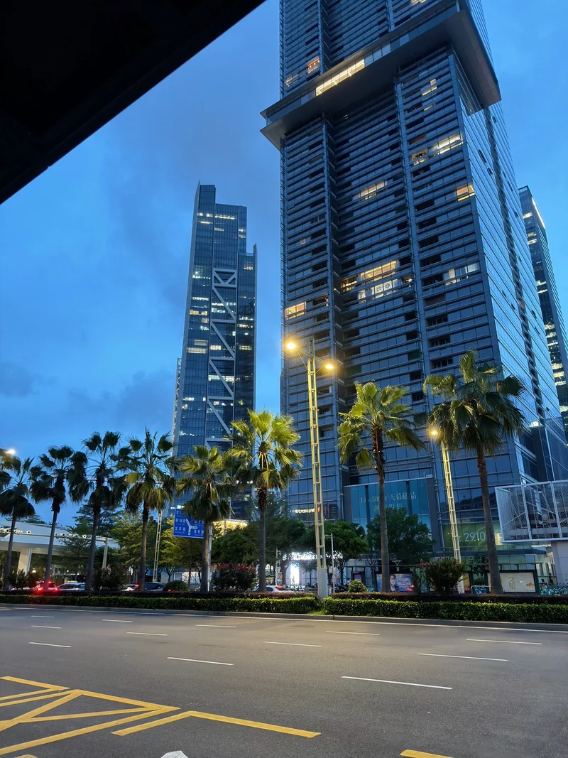 Blue-hour street scene from the original post, with towers, palms and streetlights